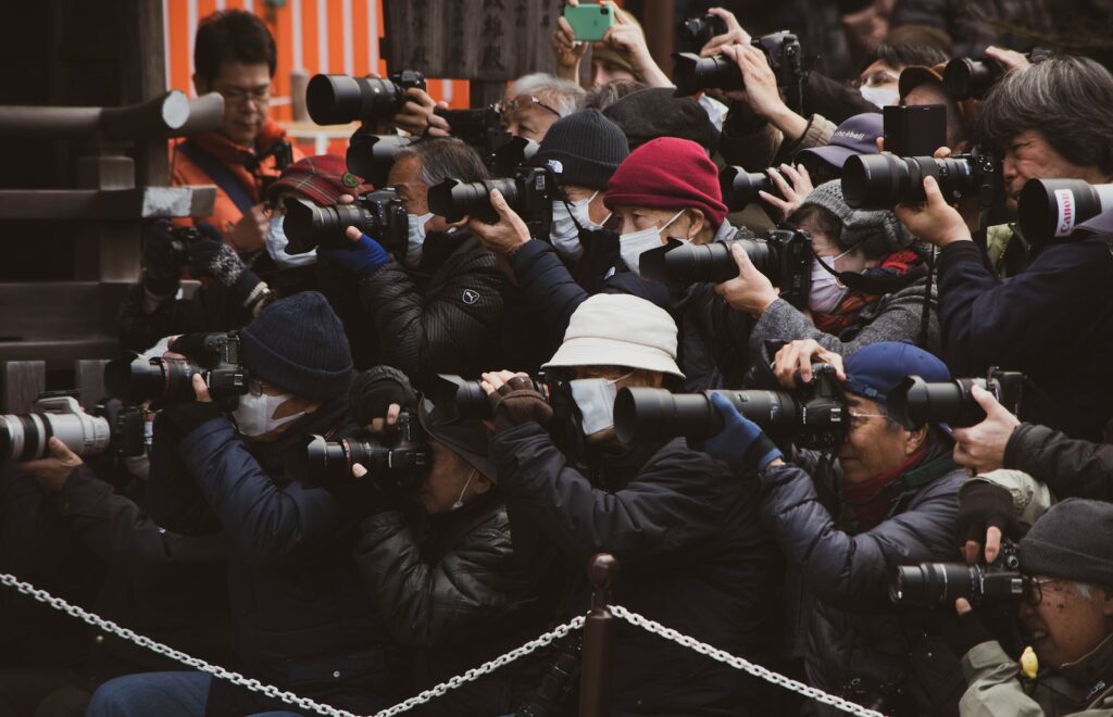 people in black jacket taking photo