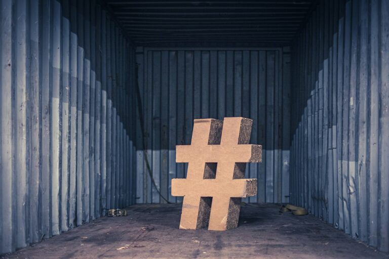 brown ampersand concrete statue inside an intermodal container